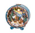 3D wooden puzzle night light depicting a Christmas village with snow-covered cottages and mountains, illuminated in warm colors.