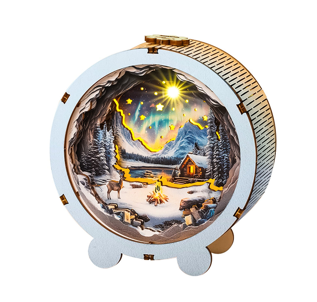Aurora World Kit 3D wooden puzzle night light featuring a snowy landscape with mountains and a cozy cabin.
