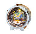 Aurora World Kit 3D wooden puzzle night light featuring a snowy landscape with mountains and a cozy cabin.