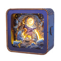 3D wooden puzzle night light featuring nativity scene with angels, Mary, Joseph, and baby Jesus illuminated against a starry background.