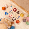 Personalized wooden baby name puzzle 'Jackie' with colorful sports icons, ideal for educational play.