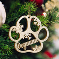 Personalized wooden dog paw ornament with snowflakes, perfect for holiday tree decorating.
